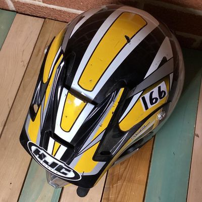 Sale Photo Thumbnail #233: HJC CL-X4 Fuel off-road/motocross motorcycle helmet in yellow, silver, black, and white graphics. Marked as Adult Large size with Advanced Ventilation System (AVS). Inner label indicates manufacturing date of September 2001. Features visor, chin guard ven