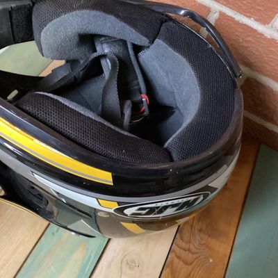 Sale Photo Thumbnail #239: HJC CL-X4 Fuel off-road/motocross motorcycle helmet in yellow, silver, black, and white graphics. Marked as Adult Large size with Advanced Ventilation System (AVS). Inner label indicates manufacturing date of September 2001. Features visor, chin guard ven