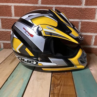 Sale Photo Thumbnail #240: HJC CL-X4 Fuel off-road/motocross motorcycle helmet in yellow, silver, black, and white graphics. Marked as Adult Large size with Advanced Ventilation System (AVS). Inner label indicates manufacturing date of September 2001. Features visor, chin guard ven