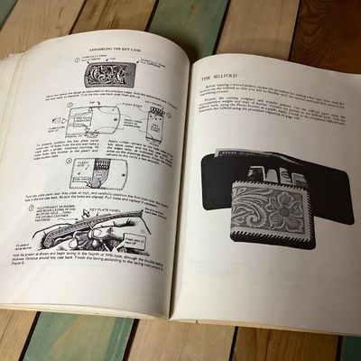 Sale Photo Thumbnail #247: Vintage instruction book titled 'Leatherwork Manual' by Al Stohlman, A. D. Patten, and J. A. Wilson. Softcover publication featuring detailed illustrations, diagrams, and step-by-step techniques for leather crafting, carving, tool usage, and assembling it