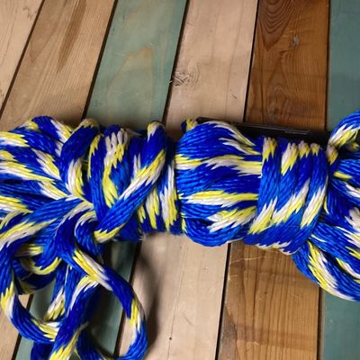 Sale Photo Thumbnail #257: Sevylor multi-colored braided tow rope, suitable for water sports, tubing, or boating. Features blue, yellow, and white strands with an attached black Sevylor floating sleeve/handle. Appears in good overall condition with minimal wear.