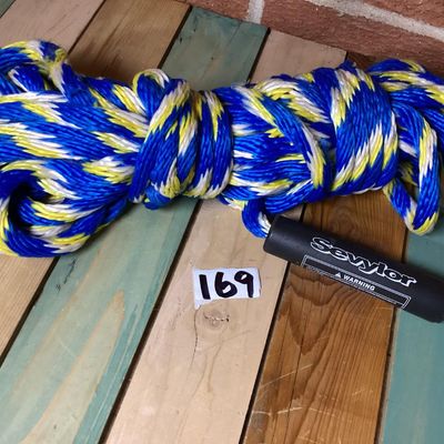 Sale Photo Thumbnail #255: Sevylor multi-colored braided tow rope, suitable for water sports, tubing, or boating. Features blue, yellow, and white strands with an attached black Sevylor floating sleeve/handle. Appears in good overall condition with minimal wear.