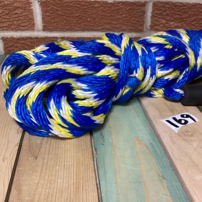 Sale Photo Thumbnail #256: Sevylor multi-colored braided tow rope, suitable for water sports, tubing, or boating. Features blue, yellow, and white strands with an attached black Sevylor floating sleeve/handle. Appears in good overall condition with minimal wear.