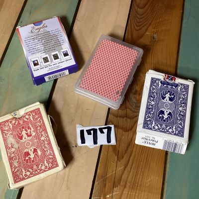 Sale Photo Thumbnail #295: Group of 4 playing card decks. Includes two Hoyle official poker size decks (one red Nevada Finish, one blue), one Eagles themed deck, and one promotional Paylocity deck in a clear plastic case. Boxes show some light wear and age.