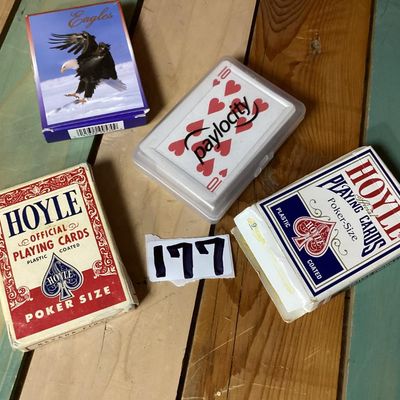Sale Photo Thumbnail #294: Group of 4 playing card decks. Includes two Hoyle official poker size decks (one red Nevada Finish, one blue), one Eagles themed deck, and one promotional Paylocity deck in a clear plastic case. Boxes show some light wear and age.