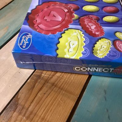 Sale Photo Thumbnail #301: Lot includes a classic Connect 4 board game by Hasbro Gaming, brand new in its original factory shrink wrap, and a wooden checkerboard/chessboard by Cardinal Industries. Both items are in clean condition; Connect 4 is unopened.