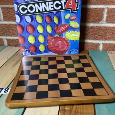 Sale Photo Thumbnail #298: Lot includes a classic Connect 4 board game by Hasbro Gaming, brand new in its original factory shrink wrap, and a wooden checkerboard/chessboard by Cardinal Industries. Both items are in clean condition; Connect 4 is unopened.