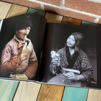 Sale Photo Thumbnail #305: Hardcover photography book titled 'In Focus: National Geographic Greatest Portraits'. Features 280 portrait photographs spanning over a century. Includes original dust jacket. Dust jacket shows some wear and a tear on the back corner, but internal pages r