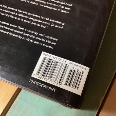 Sale Photo Thumbnail #306: Hardcover photography book titled 'In Focus: National Geographic Greatest Portraits'. Features 280 portrait photographs spanning over a century. Includes original dust jacket. Dust jacket shows some wear and a tear on the back corner, but internal pages r