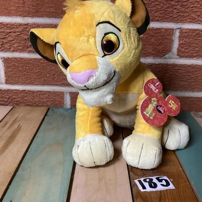 Sale Photo Thumbnail #347: Disney The Lion King Simba plush lion cub toy. Features original Kohl's Cares paper hang tags attached. In good condition with clean fabric, embroidered facial details, and soft plush material.