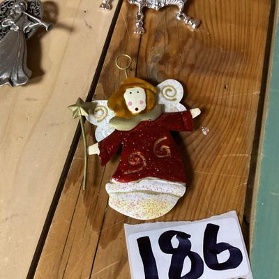 Sale Photo Thumbnail #354: Lot of 3 decorative brooches featuring an angel with a trumpet, a painted angel holding a wand/star, and a silver-tone pig figure. Each piece measures approximately 2 to 4 inches long. Pre-owned condition with light surface wear visible.