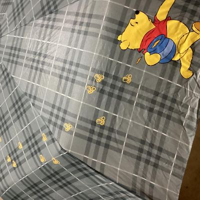 Sale Photo Thumbnail #362: Lot of Disney Winnie the Pooh collectibles including a Cupid Valentine plush with wings, a honey pot, bow and arrow; a blue plaid umbrella with Pooh graphic and honey pot handle; and a quilted Christmas themed pot holder. Items show light wear consistent 