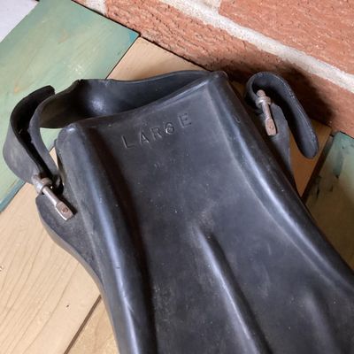 Sale Photo Thumbnail #366: Pair of vintage black rubber swim/scuba fins marked 'WATERLUNG 707' and size 'LARGE'. Features open heel with adjustable heel straps and metal buckles. Fins show signs of age and wear including surface marks and scuffs consistent with light use. Rubber re