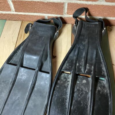 Sale Photo Thumbnail #367: Pair of vintage black rubber swim/scuba fins marked 'WATERLUNG 707' and size 'LARGE'. Features open heel with adjustable heel straps and metal buckles. Fins show signs of age and wear including surface marks and scuffs consistent with light use. Rubber re