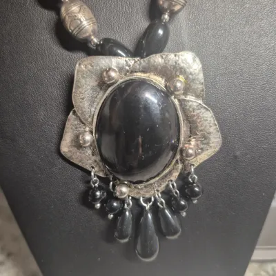 Sale Photo Thumbnail #270: Art Deco Victorian Revival Necklace & toggle bracelet
White metal pendant is covered with black set paste stones and center cabochon is black glass.
Chain comprised of black glass tube beads & Ornate silver bead / glass beads
total length 20" w/ 3"extensi