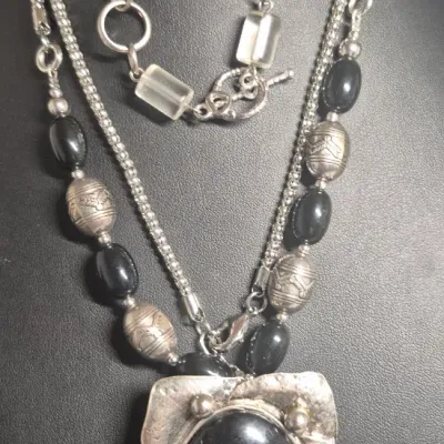 Sale Photo Thumbnail #269: Art Deco Victorian Revival Necklace & toggle bracelet
White metal pendant is covered with black set paste stones and center cabochon is black glass.
Chain comprised of black glass tube beads & Ornate silver bead / glass beads
total length 20" w/ 3"extensi