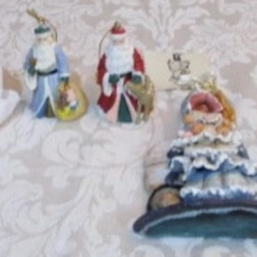 Sale Photo Thumbnail #377: 2 Santa bells, 4 Santas through the years, 1 Teddy bear with Santa hat, 1 girl with doll, See pictures