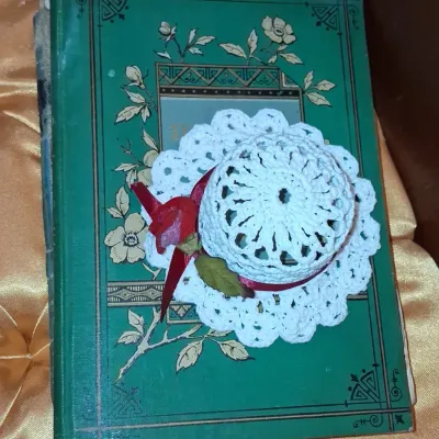 Sale Photo Thumbnail #477: Victorian era decorative green book with crochet hat ornament