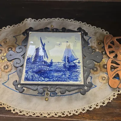 Sale Photo Thumbnail #511: Delft style ceramic tile trivet with ornate cast iron frame