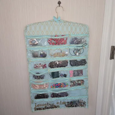 Sale Photo Thumbnail #759: Hanging jewelry organizer with assorted costume jewelry
