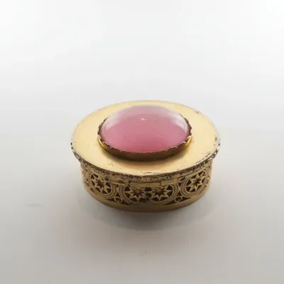 Sale Photo Thumbnail #781: Vintage gilt metal and pink cabochon pill box with filigree detail