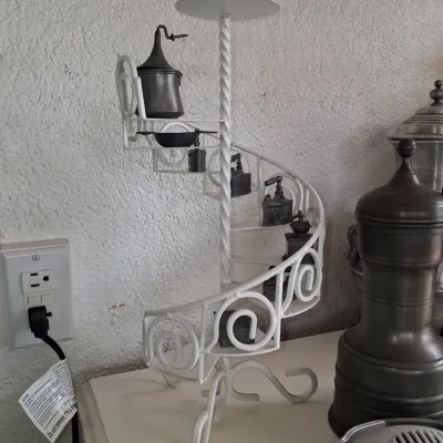 Sale Photo Thumbnail #783: Vintage miniature sad iron collection on white spiral staircase stand