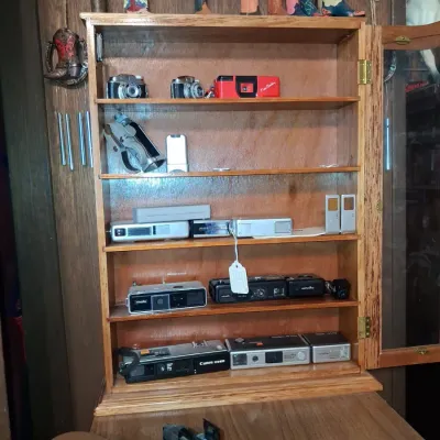 Sale Photo Thumbnail #944: Collection of vintage and subminiature cameras in oak display cabinet