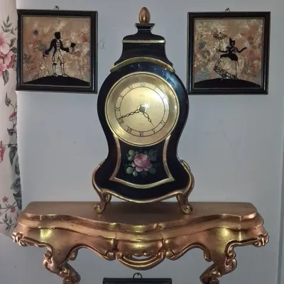 Sale Photo Thumbnail #957: Eluxa hand painted floral black lacquer mantel clock with gilt bracket