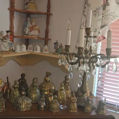 Sale Photo Thumbnail #984: Collection of vintage brass figural bells and porcelain figurines