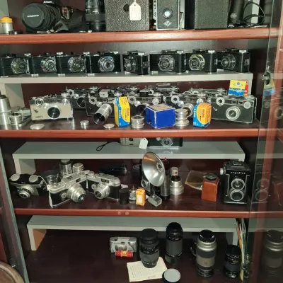 Sale Photo Thumbnail #1035: Vintage camera collection with display case