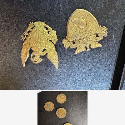 Sale Photo Thumbnail #102: Two vintage gilt brass military insignia: a U.S. eagle with shield, arrows, and olive branch, and a West Point / USMA crest with helmet and "Duty, Honor, Country" banner.
Also included: brass presidential commemorative tokens/medals, including Harry S. Tr