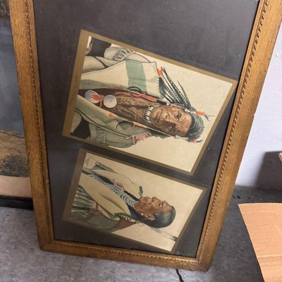 Sale Photo Thumbnail #103: Two vintage color portrait prints of Native American elders in traditional dress, mounted together in a gilt wood frame. Style is consistent with the Winold Reiss Blackfeet portraits used by the Great Northern Railway. Frame shows age wear; hanging wire a