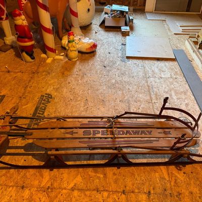 Sale Photo Thumbnail #145: Vintage Speedaway wooden sled with red stenciled "SPEEDAWAY" and arrow graphics on three slats, red steel runners, wooden steering crossbar with maker's logo, and original pull rope. Classic New England-made winter sled, perfect for display, holiday déco