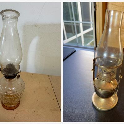 Sale Photo Thumbnail #149: Two vintage oil lamps:
• Clear pressed glass kerosene lamp with embossed scroll pattern, amber-tinted base, burner, wick, and beaded-rim glass chimney
• Brass oil lamp with clear glass chimney held in a swivel gimbal-style bracket, suitable for wall o
