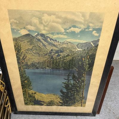 Sale Photo Thumbnail #156: Vintage hand-tinted photographic print of Bear Lake with Longs Peak beyond, Rocky Mountain National Park, Colorado. Evergreens frame a deep blue alpine lake beneath snow-streaked peaks and summer clouds. Original black wood frame with cream mat. Small pri