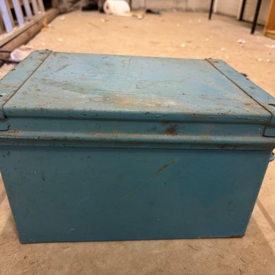 Sale Photo Thumbnail #160: Heavy-gauge steel storage box with hinged lid and wire side handles, painted blue. Useful for tools, documents, or rustic storage.
Condition: Paint wear, scratches, and surface rust.

Sold as-is, where-is. Local pickup or buyer-arranged 3rd-party pickup o