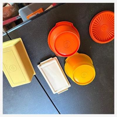 Sale Photo Thumbnail #162: Lot of vintage Tupperware in classic 1970s harvest colors:
• Orange Servalier bowl with starburst "Servalier" lid (#886)
• Gold/yellow Servalier bowl (no lid)
• Harvest gold rectangular keeper with almond lid (butter/cheese/deli keeper)
All pieces m