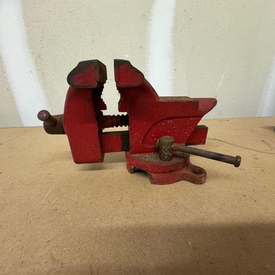Sale Photo Thumbnail #180: Red cast iron bench vise with swivel base, anvil, and serrated jaws. Paint wear and surface rust.

Sold as-is, where-is. Local pickup or buyer-arranged 3rd-party pickup only.
Disclosure: Descriptions developed with the help of AI and subject to errors and