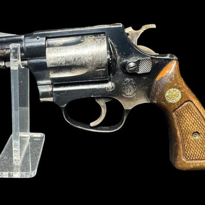 Sale Photo Thumbnail #10: This revolver has the no-dash serial number, meaning that it was issued prior to any significant mechanical changes made later by Smith & Wesson. It has the original diamond checkered wood grips. The barrel measures two inches long. This revolver shows so