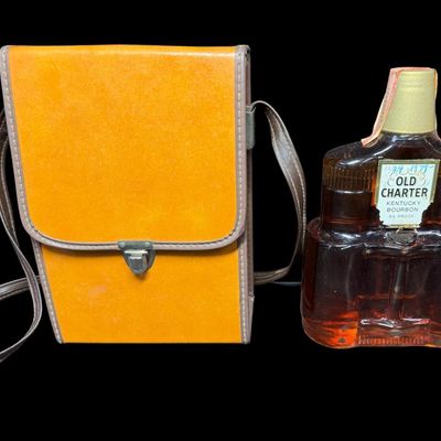 Sale Photo Thumbnail #28: This is believed to be from the 1970s. The bottle is in the shape of a pair of binoculars, and comes in a leather case. The tax stamp and label are intact. Both the bottle and case have age related wear. Measurement of case: 9.5”H x 6.25”W. Pre-auctio