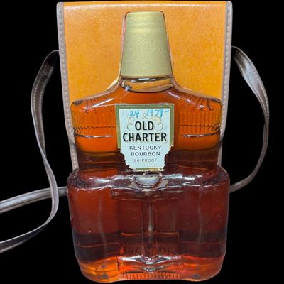 Sale Photo Thumbnail #27: This is believed to be from the 1970s. The bottle is in the shape of a pair of binoculars, and comes in a leather case. The tax stamp and label are intact. Both the bottle and case have age related wear. Measurement of case: 9.5”H x 6.25”W. Pre-auctio