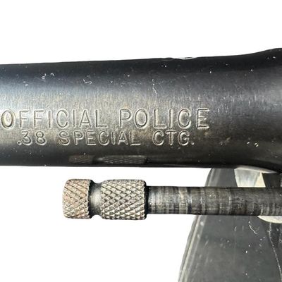 Sale Photo Thumbnail #52: This gun has the Rampant Colt logo stamped on the left side, which is crisp with no wear or re-bluing. It also has the original checkered walnut grips, which have minor wear. There are no major patches of wear to the bluing in general. There is holster we