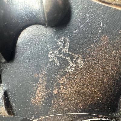 Sale Photo Thumbnail #51: This gun has the Rampant Colt logo stamped on the left side, which is crisp with no wear or re-bluing. It also has the original checkered walnut grips, which have minor wear. There are no major patches of wear to the bluing in general. There is holster we