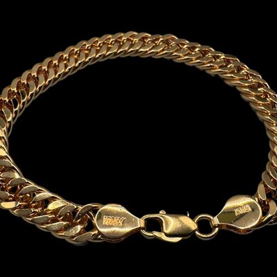 Sale Photo Thumbnail #64: This curb link bracelet has a gold vermeil wash. The clasp may need repair. Measurement: 8”L. The weight is 22.41 grams. [VY]
