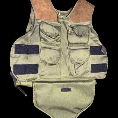 Sale Photo Thumbnail #68: This is olive drab in color, has a heavy-duty canvas/nylon blend body, and has distinctive dual brown suede/leather shooting pads on both shoulders to cushion a rifle or shotgun stock during recoil. The size is large. Pre-auction estimate: $100-$200. [RS]