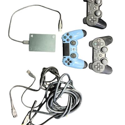 Sale Photo Thumbnail #79: Includes a PlayStation 4 Uncharted 4 Limited Edition console in blue, featuring a silkscreened silhouette of Nathan Drake, with matching controller; a PlayStation 3 console; two black controllers; a Seagate Game Drive portable external hard drive; and 38 
