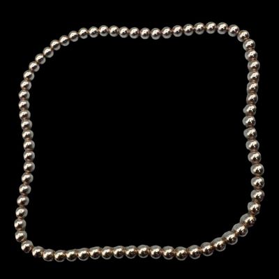 Sale Photo Thumbnail #90: This classic 3mm sterling bead bracelet is hand beaded, and has a stretch design featuring high-performance elastic that allows it to be rolled gently onto the wrist, with no clasp necessary. The beads have a smooth, polished finish. The overall length is