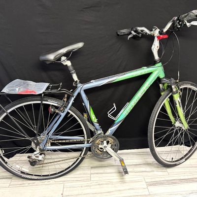 Sale Photo Thumbnail #112: Produced between 2004 and 2006, this bike features a two-tone metallic green and dark silver/gray finish. It utilizes an Alpha Custom aluminum frame. It has a 3x8-speed drivetrain (8-speed). It has a 25-inch frame. It comes with an extra NOS tube. Pre-auc