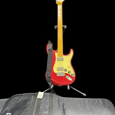 Sale Photo Thumbnail #153: This piece is believed to be completely original. It features a maple neck and fingerboard with 22 frets. It has Dual Hot vintage Alnico humbucking pickups with metal covers. The body is made of alder wood. This guitar was made in Mexico. The stand is inc