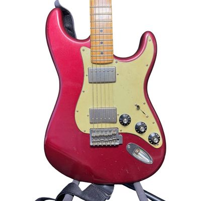 Sale Photo Thumbnail #149: This piece is believed to be completely original. It features a maple neck and fingerboard with 22 frets. It has Dual Hot vintage Alnico humbucking pickups with metal covers. The body is made of alder wood. This guitar was made in Mexico. The stand is inc